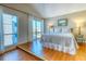 Bedroom with a queen-size bed and large windows at 175 Medallion Blvd # F, Madeira Beach, FL 33708