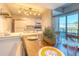 Bright dining area with wooden table and view to kitchen at 175 Medallion Blvd # F, Madeira Beach, FL 33708