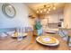 Dining area with wooden table and blue chairs at 175 Medallion Blvd # F, Madeira Beach, FL 33708