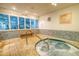 Relax in this community hot tub with surrounding tile and gym view at 175 Medallion Blvd # F, Madeira Beach, FL 33708