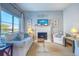 Bright living room featuring comfortable sofas, a fireplace, and large windows at 175 Medallion Blvd # F, Madeira Beach, FL 33708