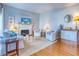 Living room with fireplace and white slipcovered furniture at 175 Medallion Blvd # F, Madeira Beach, FL 33708