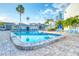 Inviting community pool with lounge chairs and patio area at 175 Medallion Blvd # F, Madeira Beach, FL 33708