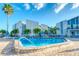 Relaxing community pool with surrounding patio and lounge chairs at 175 Medallion Blvd # F, Madeira Beach, FL 33708