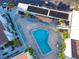 Community pool with surrounding lounge chairs and patio area at 175 Medallion Blvd # F, Madeira Beach, FL 33708