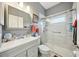 Updated bathroom with gray vanity, walk-in shower, and modern fixtures at 18520 Oak Way Dr, Hudson, FL 34667
