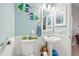 Small bathroom with pedestal sink and decorative accents at 18520 Oak Way Dr, Hudson, FL 34667