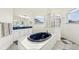 Spa-like bathroom featuring a large soaking tub and glass block shower at 18520 Oak Way Dr, Hudson, FL 34667