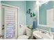 Charming bathroom with white sink, toilet, and stained glass window at 18520 Oak Way Dr, Hudson, FL 34667