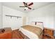 Spacious bedroom with a queen bed, wood floors, and built-in shelving at 18520 Oak Way Dr, Hudson, FL 34667