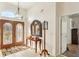 Bright and spacious foyer with a wooden console table and mirror at 18520 Oak Way Dr, Hudson, FL 34667