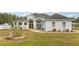 Beautiful light blue house with a large front yard and landscaping at 18520 Oak Way Dr, Hudson, FL 34667