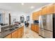 Kitchen with light wood cabinets, granite counters, and stainless steel appliances at 18520 Oak Way Dr, Hudson, FL 34667