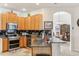 Kitchen with light wood cabinets, granite counters, and stainless steel appliances at 18520 Oak Way Dr, Hudson, FL 34667