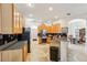 Kitchen with light wood cabinets, granite counters, and stainless steel appliances at 18520 Oak Way Dr, Hudson, FL 34667