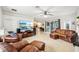 Spacious living room featuring leather furniture and a large TV at 18520 Oak Way Dr, Hudson, FL 34667