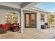 Covered patio with seating area, adjacent to the pool and screen enclosure at 18520 Oak Way Dr, Hudson, FL 34667