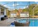 Relaxing pool area with covered patio and wicker seating at 18520 Oak Way Dr, Hudson, FL 34667
