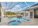 Inviting screened pool and spa with ample lounge chairs at 18520 Oak Way Dr, Hudson, FL 34667