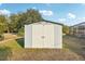 White storage shed with double doors at 18520 Oak Way Dr, Hudson, FL 34667