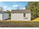 Gray storage shed with window box at 18520 Oak Way Dr, Hudson, FL 34667
