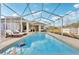 Refreshing swimming pool with a screened enclosure at 18520 Oak Way Dr, Hudson, FL 34667