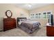 Guest bedroom with a queen-size bed and wood dresser at 18732 Wimbledon Cir, Lutz, FL 33558