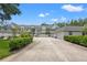 Exterior view of charming townhouses with lush landscaping and spacious driveway at 18732 Wimbledon Cir, Lutz, FL 33558