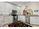 Modern kitchen featuring white cabinets and granite countertops at 18732 Wimbledon Cir, Lutz, FL 33558