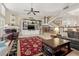 Cozy living room featuring a fireplace, custom built-ins, and a staircase leading to the upper level at 18732 Wimbledon Cir, Lutz, FL 33558