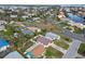 An aerial view of a house with a reddish-brown metal roof in a waterfront community at 1885 Mississippi Ne Ave, St Petersburg, FL 33703