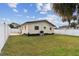 Large backyard with grassy area and white vinyl fence at 1885 Mississippi Ne Ave, St Petersburg, FL 33703