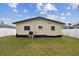 Grass yard with a white fence and palm trees at 1885 Mississippi Ne Ave, St Petersburg, FL 33703