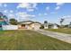 House exterior showcasing a spacious lawn and driveway at 1885 Mississippi Ne Ave, St Petersburg, FL 33703