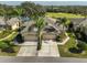 Exterior view of two-story house with double garage and landscaped yard at 2019 Acadia Greens Dr # 34, Sun City Center, FL 33573