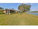 Landscaped backyard featuring a pond and golf course view at 2019 Acadia Greens Dr # 34, Sun City Center, FL 33573