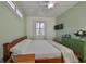 Serene bedroom with queen bed and wood flooring at 2019 Acadia Greens Dr # 34, Sun City Center, FL 33573