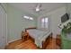 Cozy bedroom with a queen-size bed and wood flooring at 2019 Acadia Greens Dr # 34, Sun City Center, FL 33573