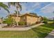 Single story house with tan exterior, landscaping, and walkway at 2019 Acadia Greens Dr # 34, Sun City Center, FL 33573