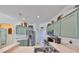 Bright kitchen features stainless steel appliances and green cabinets at 2019 Acadia Greens Dr # 34, Sun City Center, FL 33573
