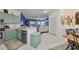 Bright kitchen with light green cabinets and stainless steel appliances at 2019 Acadia Greens Dr # 34, Sun City Center, FL 33573