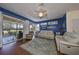 Living room with hardwood floors, blue walls, and access to patio at 2019 Acadia Greens Dr # 34, Sun City Center, FL 33573