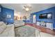 Bright living room with hardwood floors, blue walls, and a comfy couch at 2019 Acadia Greens Dr # 34, Sun City Center, FL 33573