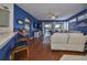 Open living area with hardwood floors, blue walls, and white couch at 2019 Acadia Greens Dr # 34, Sun City Center, FL 33573