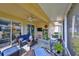 Relaxing screened lanai with seating area, ceiling fan, and view of backyard at 2019 Acadia Greens Dr # 34, Sun City Center, FL 33573