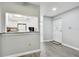 Bright entryway with white door and kitchen peek at 2650 Countryside Blvd # C309, Clearwater, FL 33761