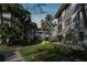 Evening view of condo building with landscaping and walkway at 2650 Countryside Blvd # C309, Clearwater, FL 33761