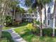 Exterior of building with lush landscaping and walkways at 2650 Countryside Blvd # C309, Clearwater, FL 33761