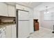 Kitchen with white cabinets and granite at 2650 Countryside Blvd # C309, Clearwater, FL 33761