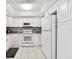 White kitchen with granite countertops and appliances at 2650 Countryside Blvd # C309, Clearwater, FL 33761
